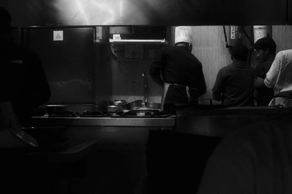 Chefs preparing dishes in a restaurant kitchen